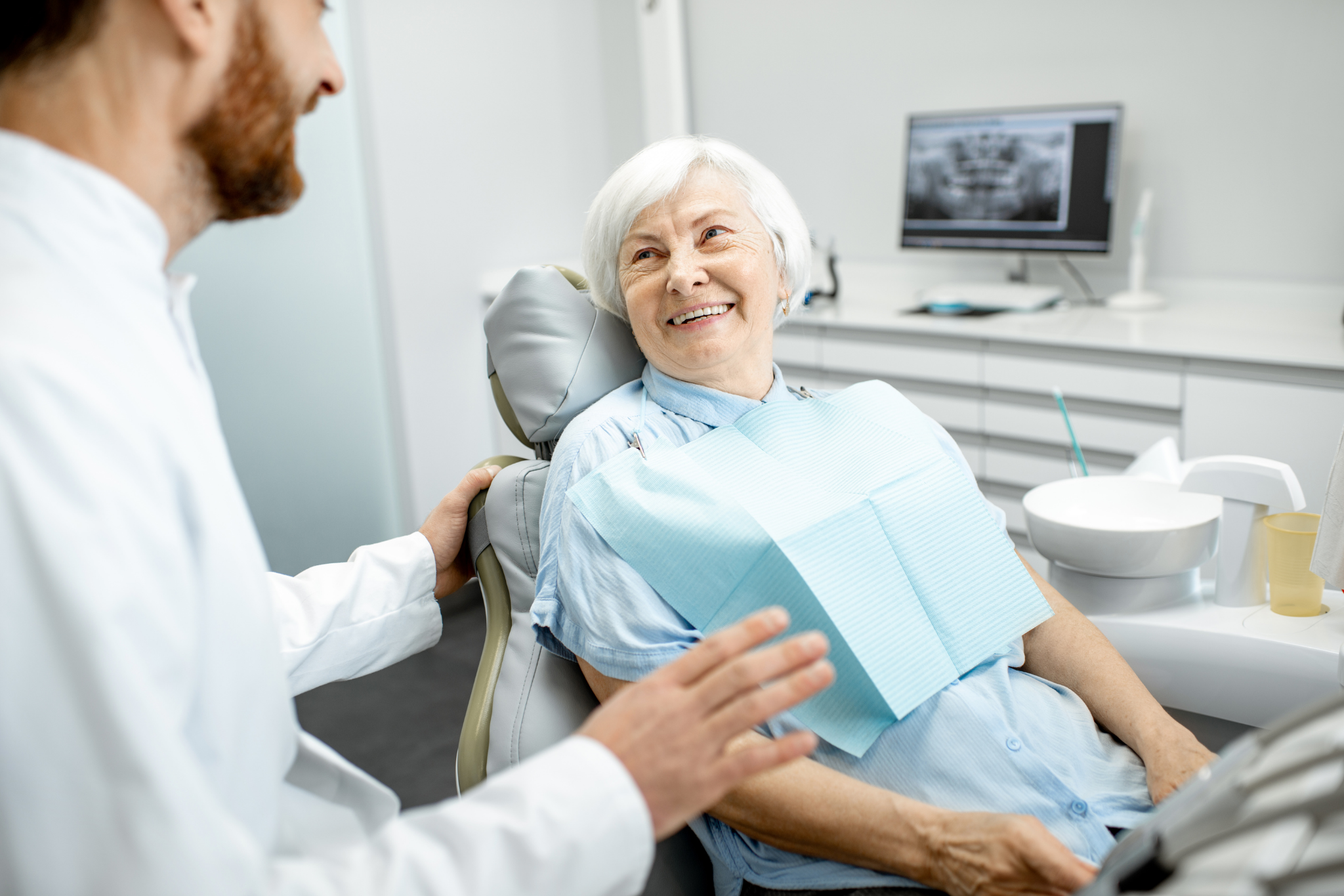 senior woman consulting dentist about getting dentures in Northern Nevada